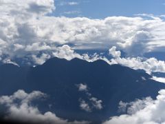 03C Clouds Surround The Hills Ahead From The Helicopter To Fly To Carstensz Pyramid Base Camp